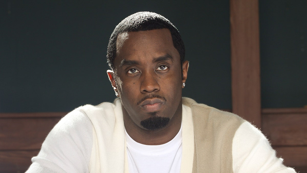 Sean Diddy Combs wears white cardigan