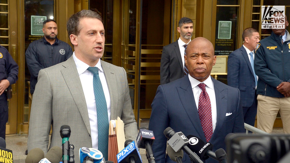 New York City Mayor Eric Adams and attorney Alex Spiro speak to the media while departing federal court