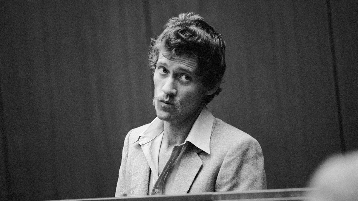 John Holmes wearing a suit inside a courtroom