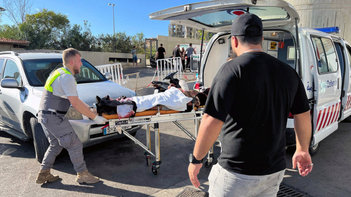 Civil Defense first-responders carry a wounded man