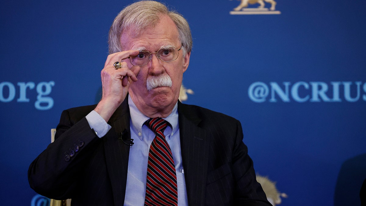 Former National Security Adviser John Bolton touching his glasses