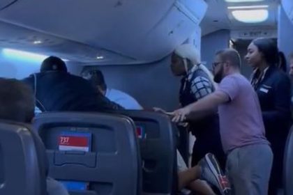 Passengers intervene on flight when man allegedly attacks woman next to him, video shows