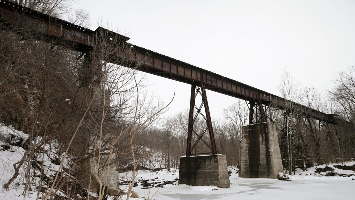 Snow covers the water of Deer creek as the Monon High Bridge towers above, Wednesday, Feb. 9, 2022 in Delphi.