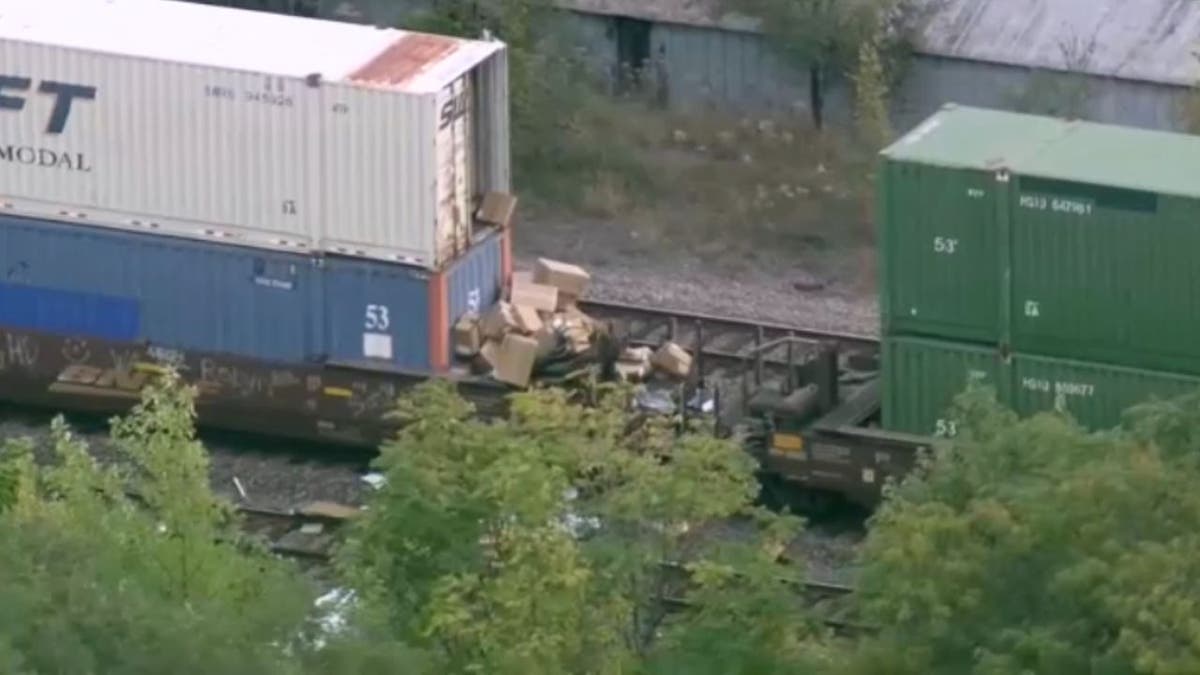 Boxes spill out from a freight train