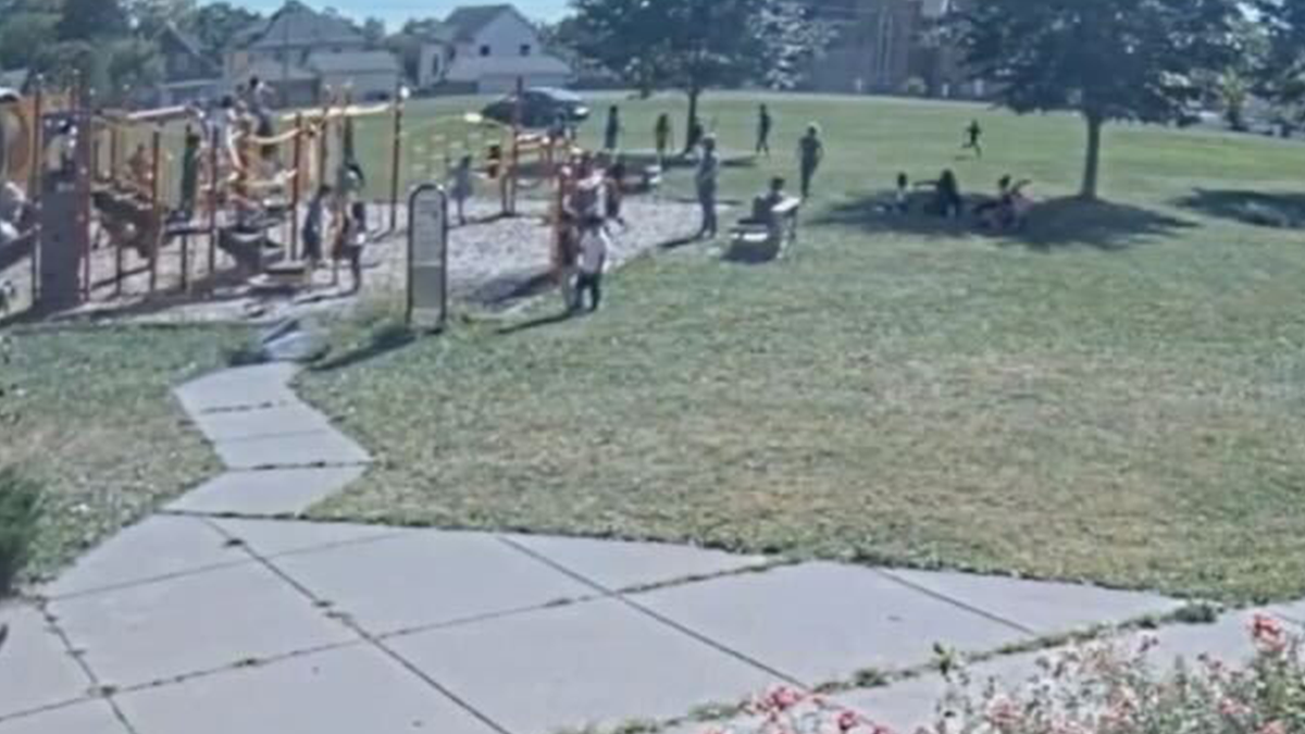 Child driving a car near a playground