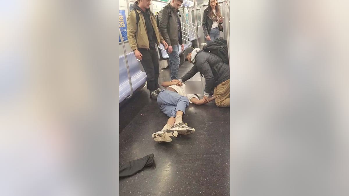 Screenshot from bystander video showing Jordan Neely being held in a chokehold on the New York City subway.