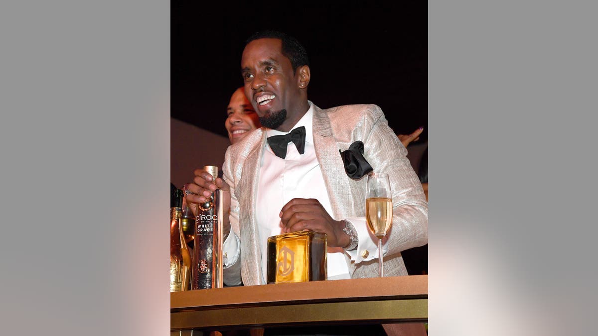 Diddy holds a bottle of Ciroc vodka at his 50th birthday party