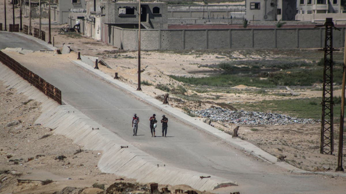 Displaced Palestinians fleeing Gaza City walk along the Israeli army corridor in the Netzarim area in central Gaza, on July 10, 2024.