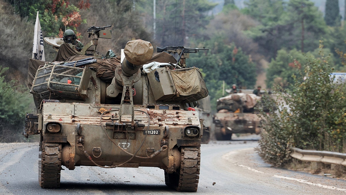 Israeli soldier rides in military vehicle