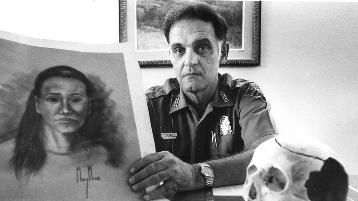 Police Chief James Meads with skull of unidentified murder victim and drawing made from the skull