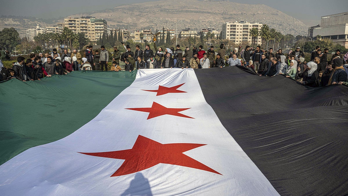 Syrians gather at Umayyad Square to celebrate the collapse of 61 years of Baath Party rule in Damascus, Syria, on Dec. 9, 2024.