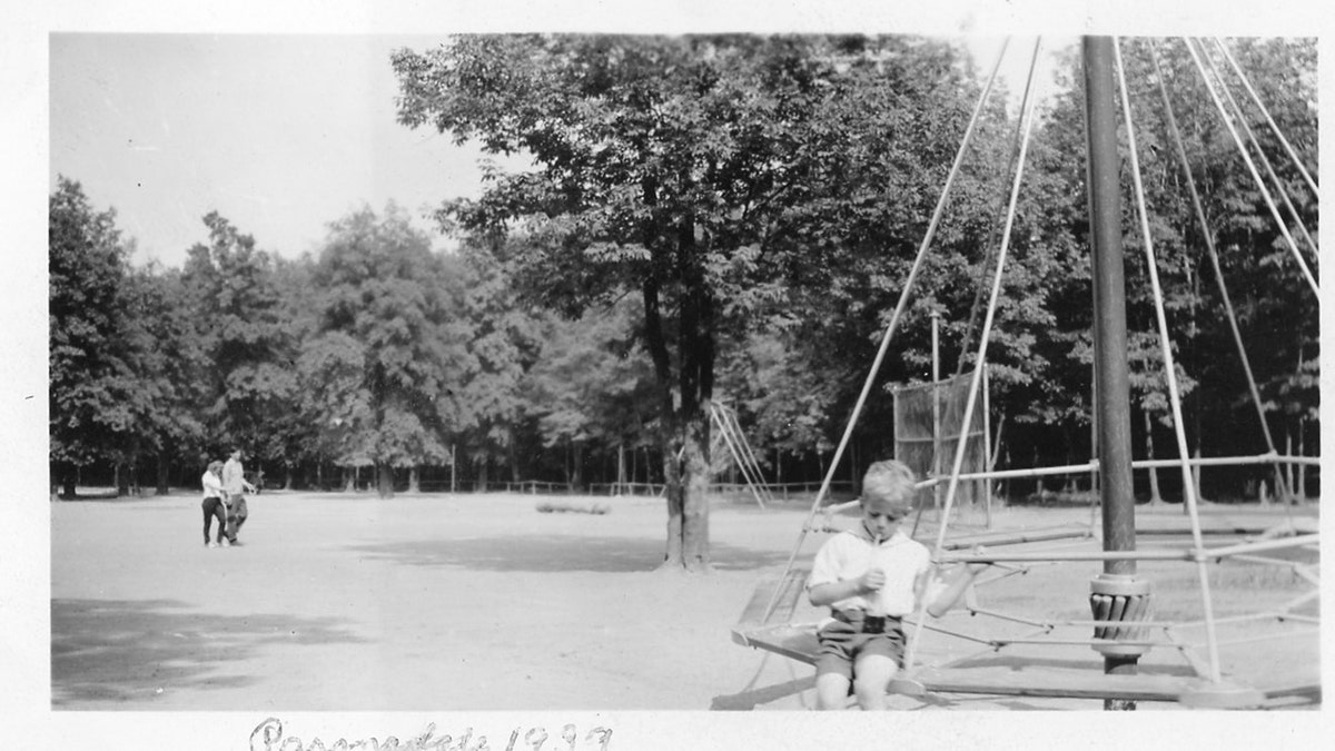 Edward Wayne Edwards sitting on a swing outdoors