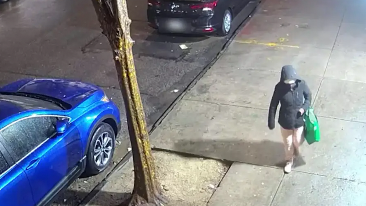 An unidentified suspect is shown walking on a sidewalk in the Bronx.