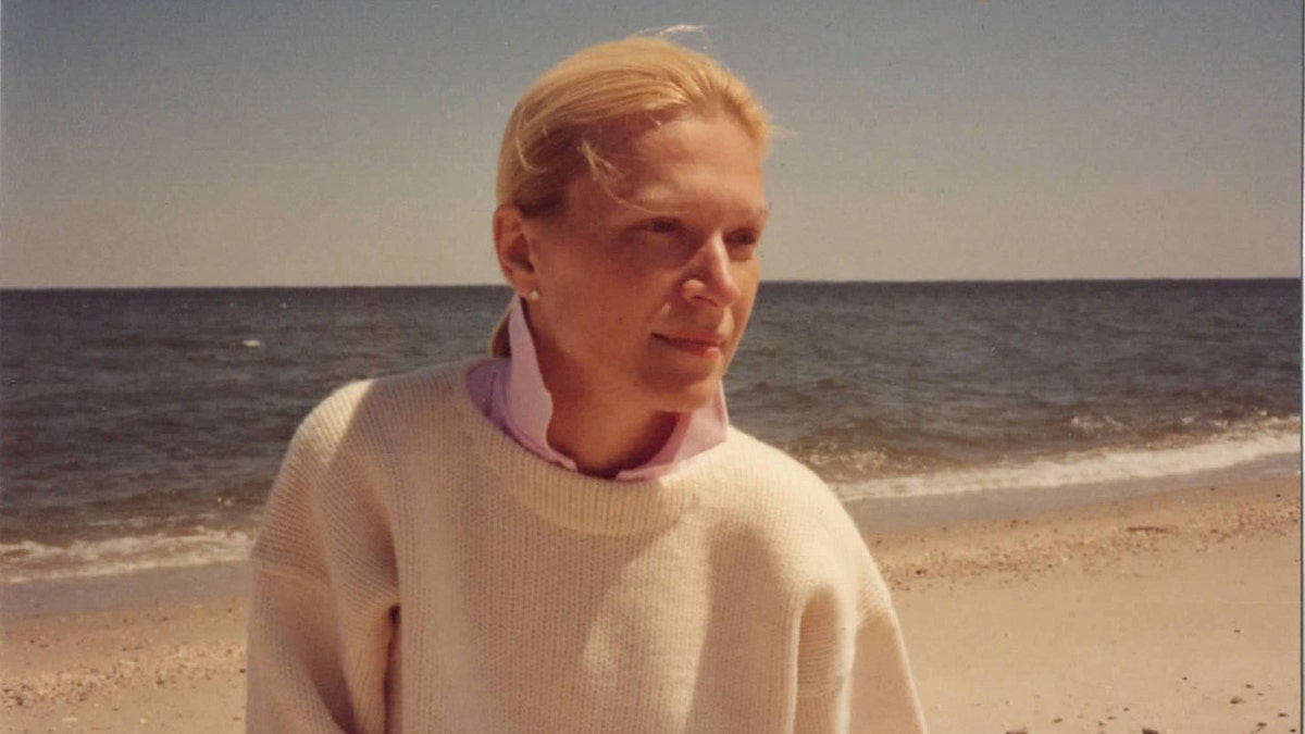 Noreen Doyle wearing a white sweater on the beach.