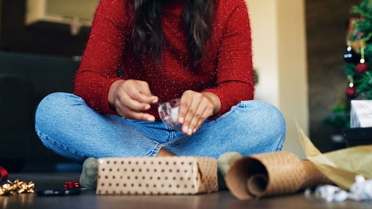 Woman wrapping Christmas gift