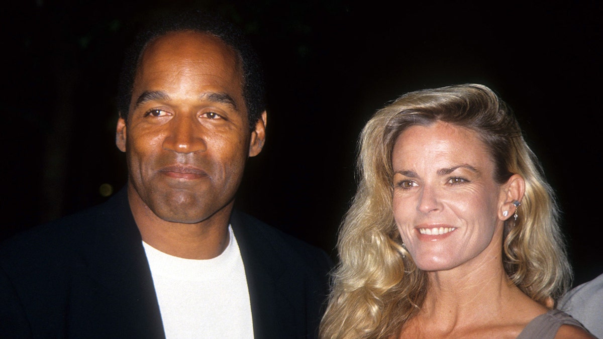 OJ Simpson and Nicole Brown Simpson walk red carpet for movie premiere.