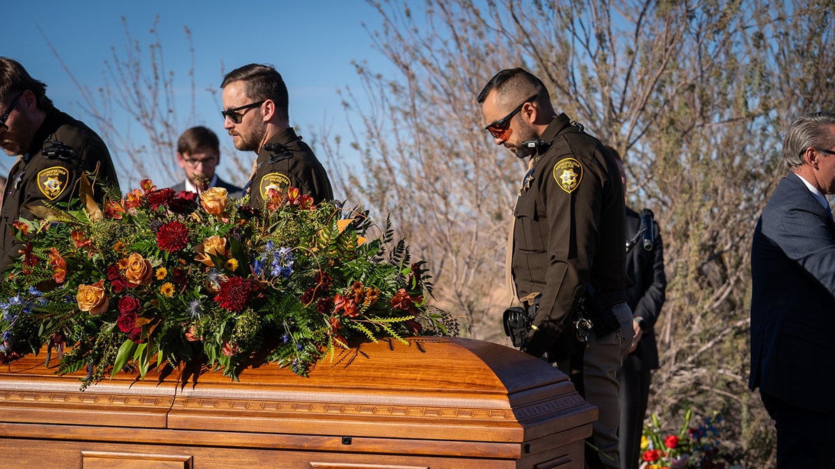 Officer Colton Pulsipher's casket with offices paying respects