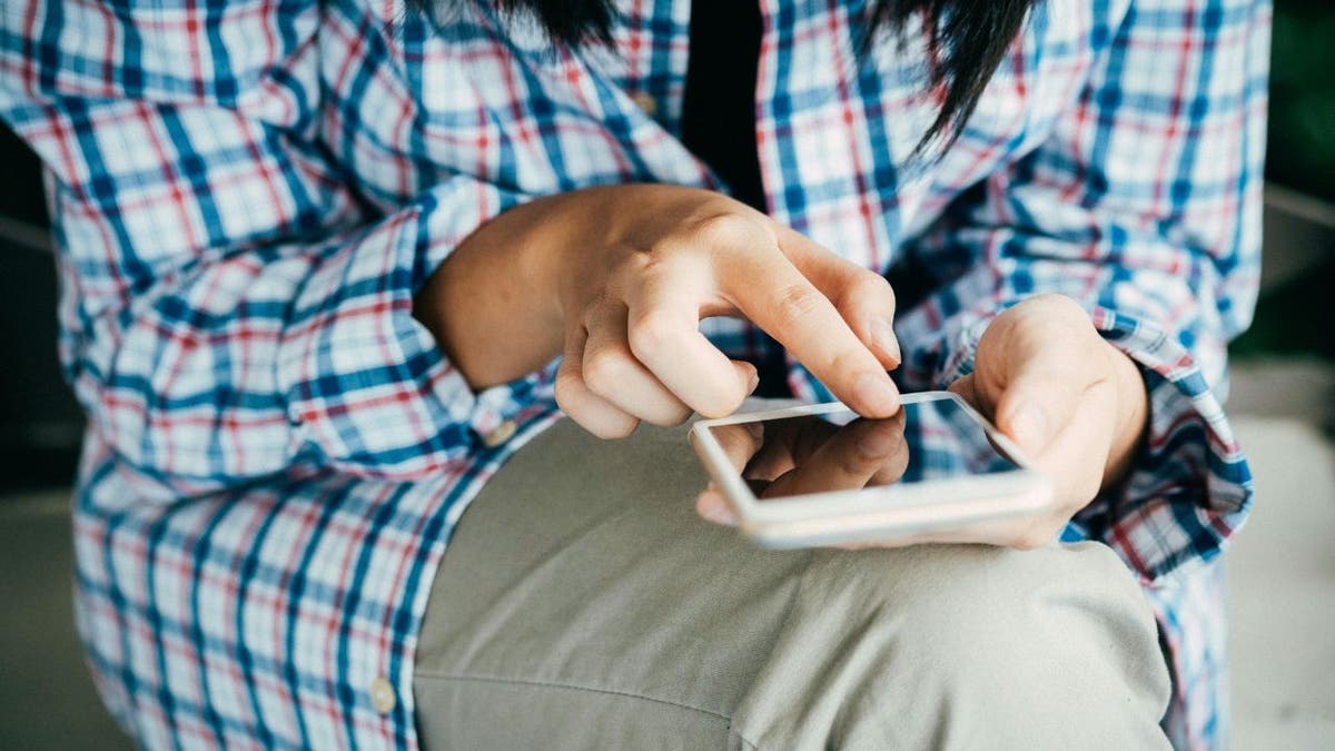 seated person texting