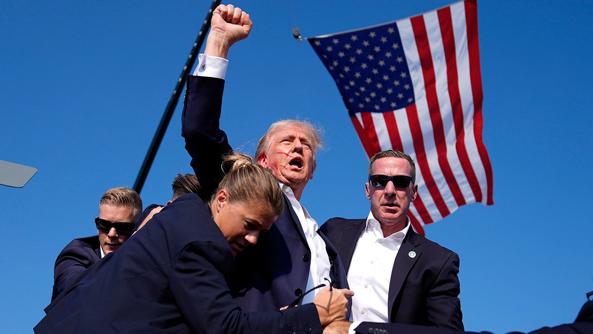 Former President Donald Trump is surrounded by U.S. Secret Service agents at a campaign rally