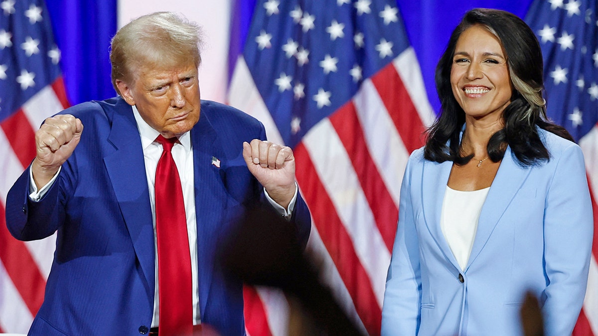 Donald Trump doing a dance move as Tulsi Gabbard laughs