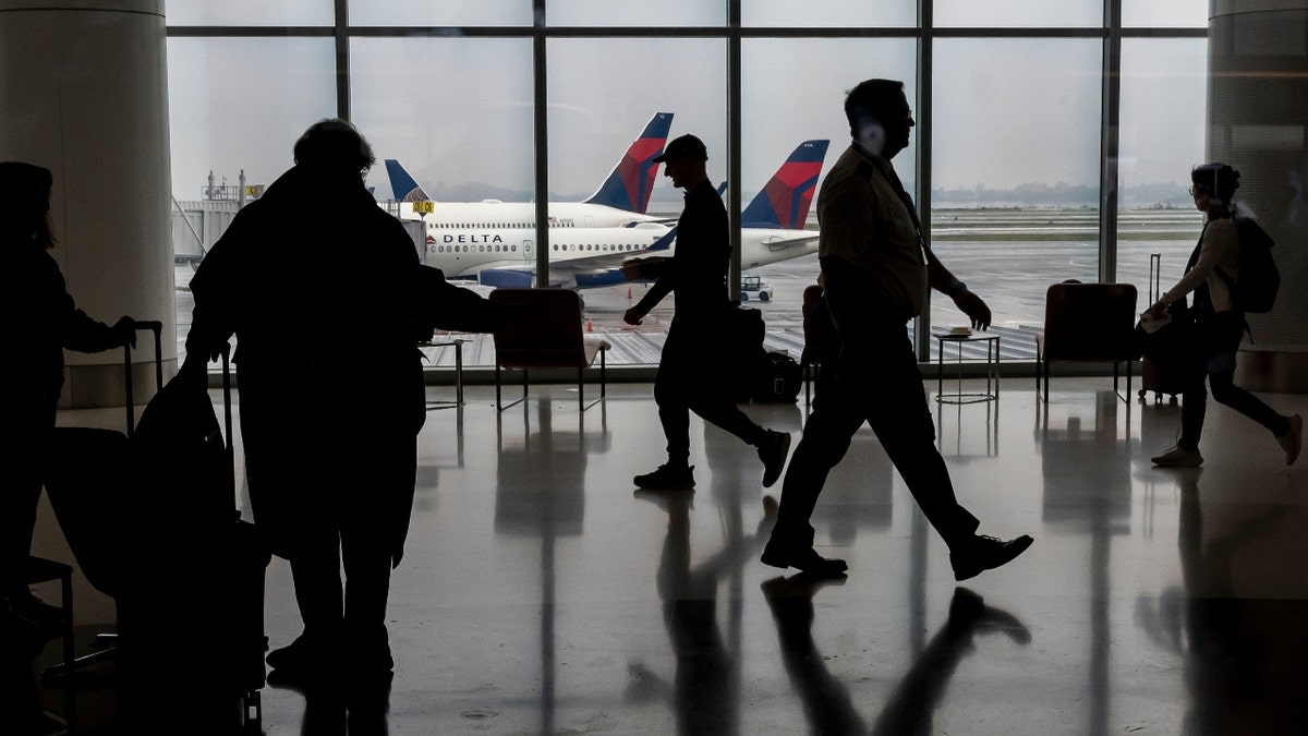 Travelers at San Francisco International Airport (SFO) in San Francisco, California, US, on Monday, Dec. 23, 2024.