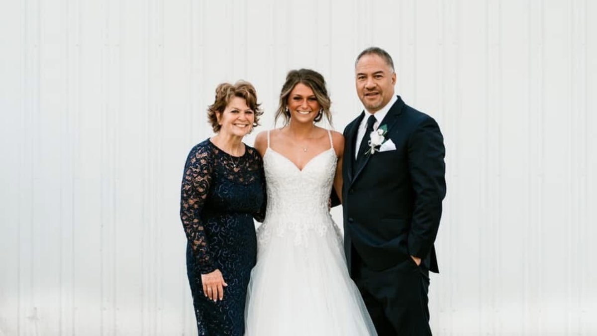 Paul and Christy Akeo pose with their daughter, Lindsey Lemke Hull, at her wedding.