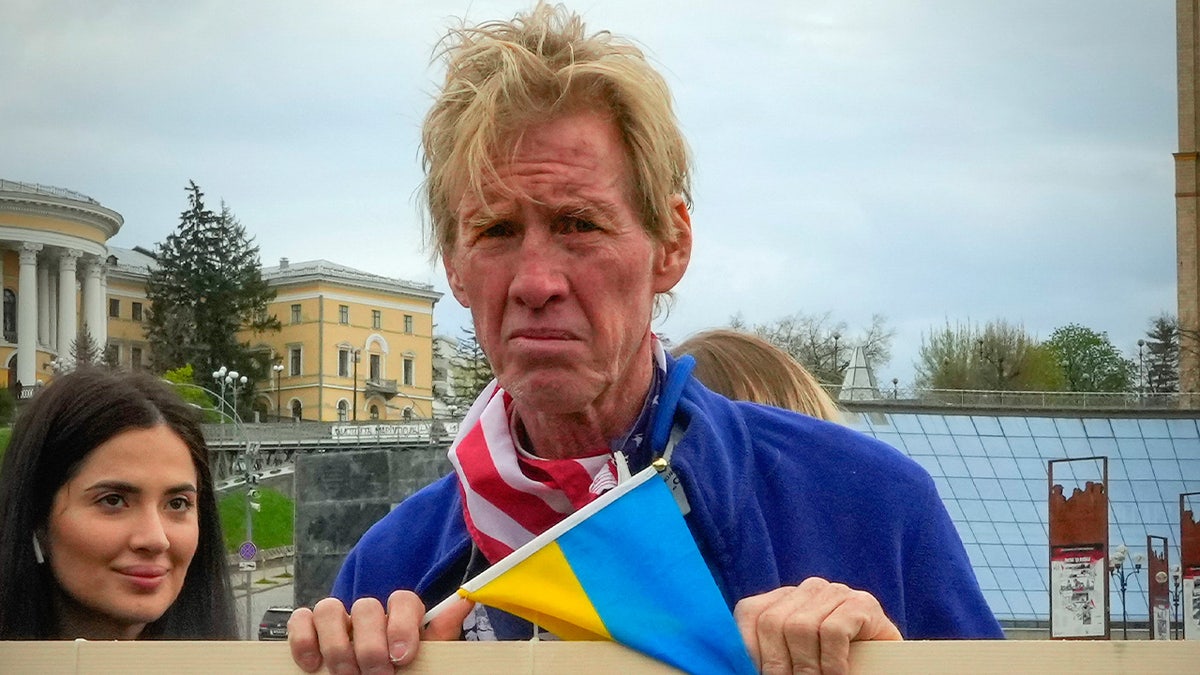 Ryan Wesley Routh takes part in a rally while holding a Ukraine flag