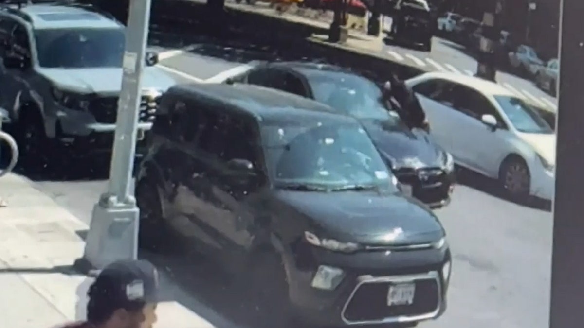 man standing at driver's window