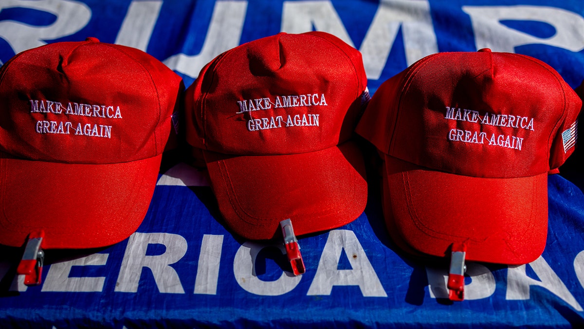 Red Make America Great Again hats on a table