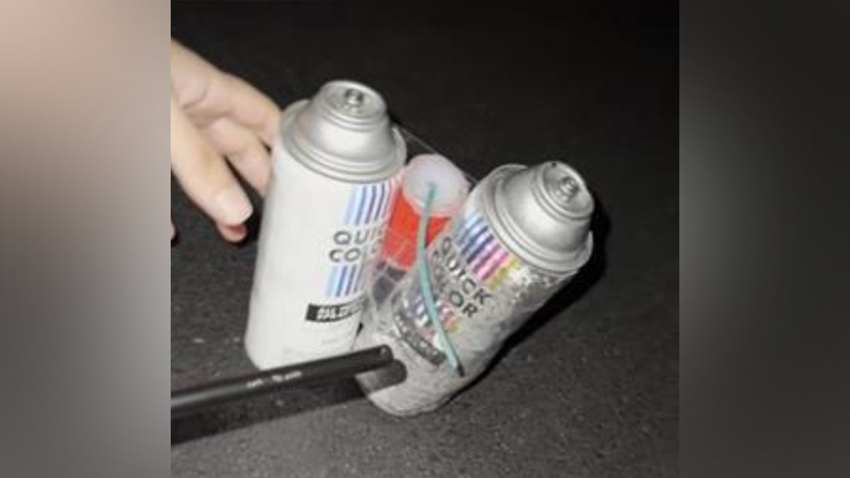 Homemade explosive device built from spray paint cans and a fuse.
