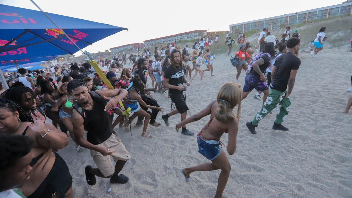 Festival goers run from the stage after someone yelled that a gun was seen on Saturday, April 19, 2025 during Orange Crush on Tybee Island.