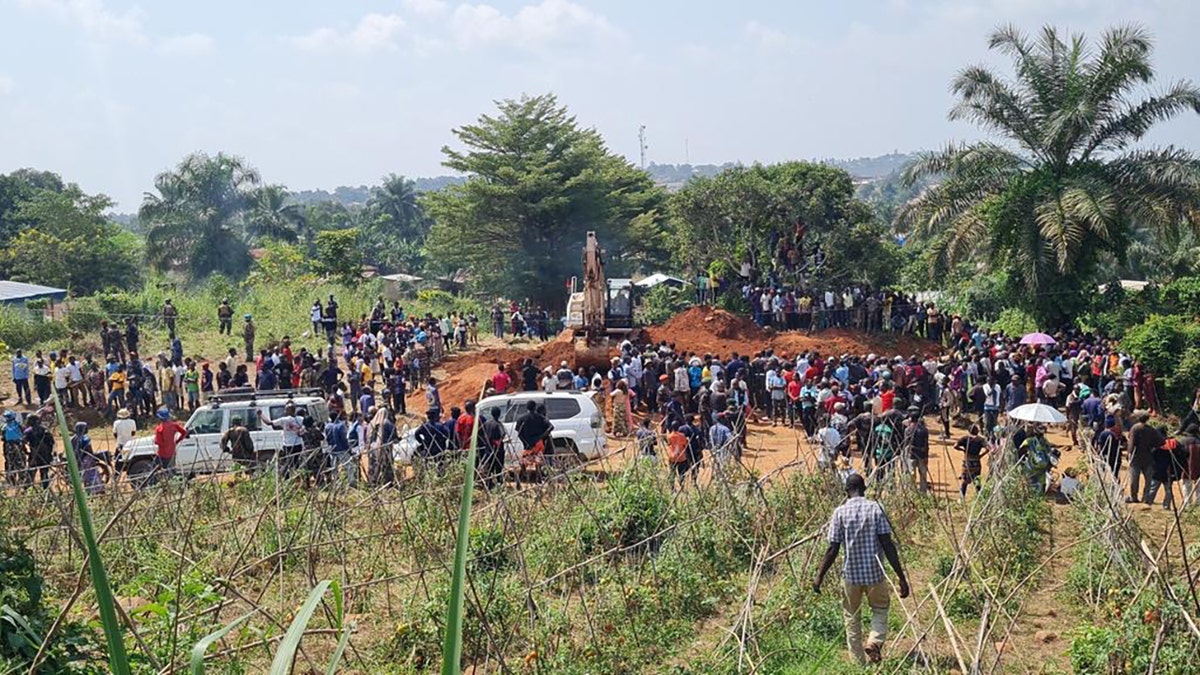 Villagers walk toward the burial site of 49 Christians killed by jihadists in the Democratic Republic of Congo.