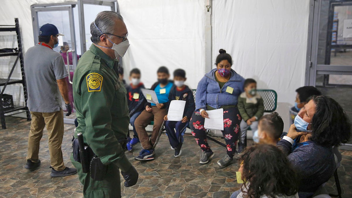 Migrants are processed at the intake area of the U.S. Customs and Border Protection facility, the main detention center for unaccompanied children in the Rio Grande Valley, in Donna, Texas, Tuesday, Mar. 30, 2021.