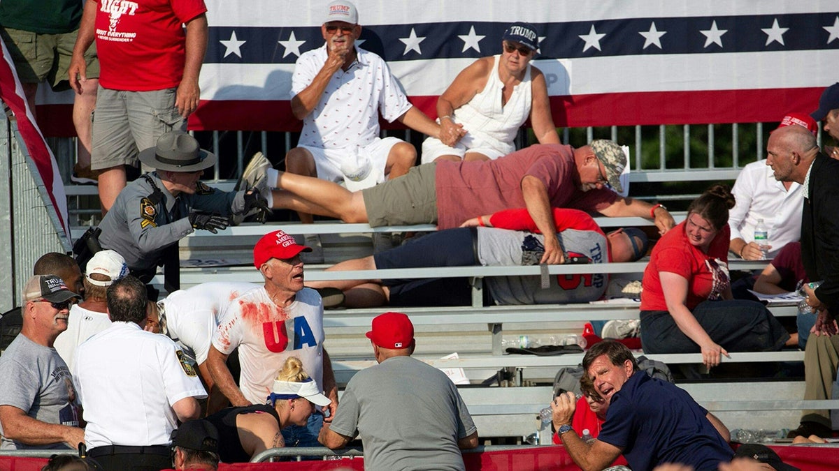 Trump supporters are seen covered with blood in the stands after guns were fired at Republican candidate Donald Trump