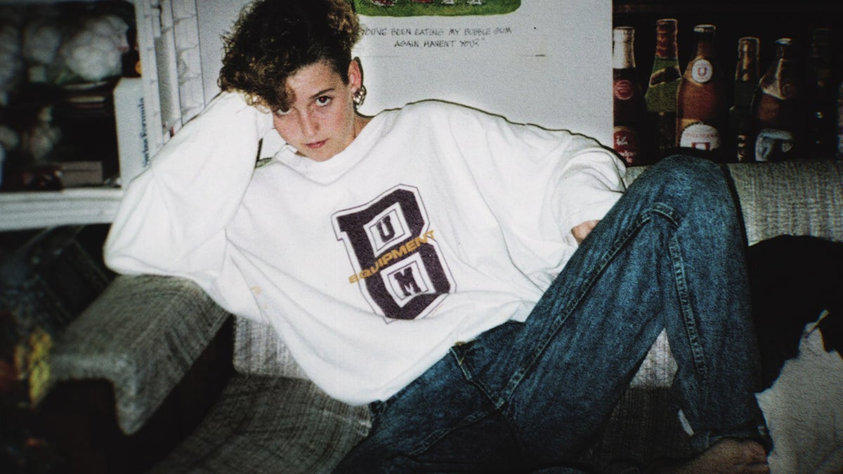 Amy Bradley wearing a white sweater and blue jeans.