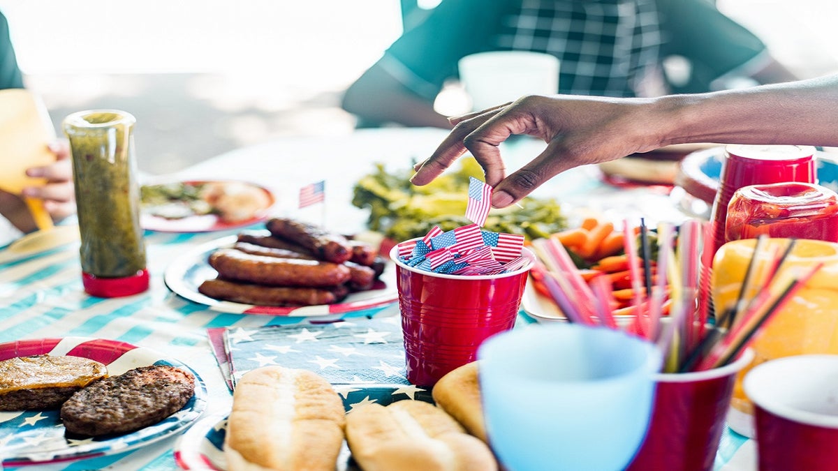 Fouth of July BBQ spread seen with people in background,