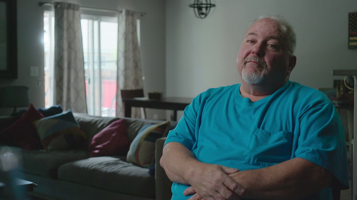 Bill Hefner wearing a bright blue shirt.