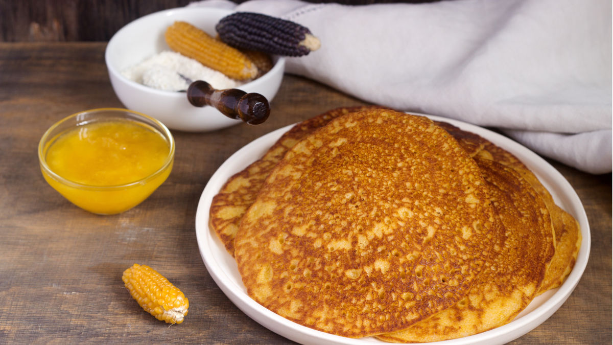 hoecakes next to butter and corn