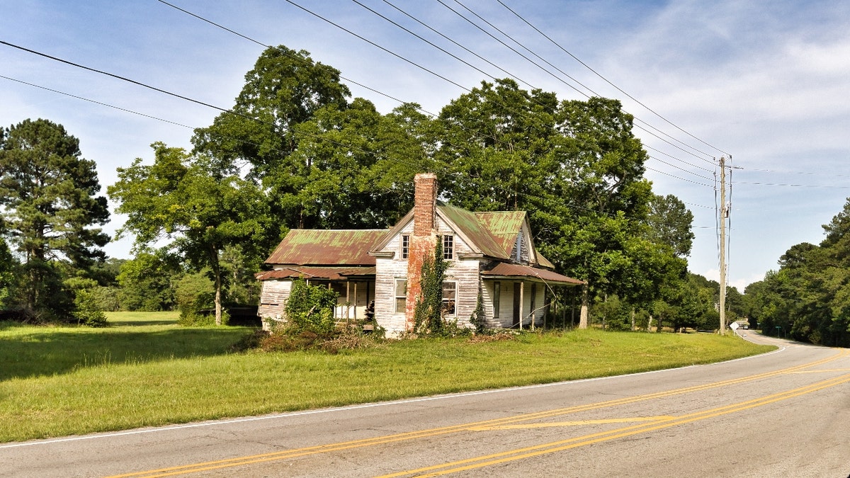 An abandoned house by a road