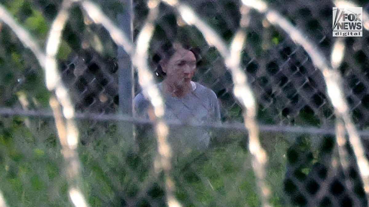 Ghislaine Maxwell is seen behind razor wire in prison