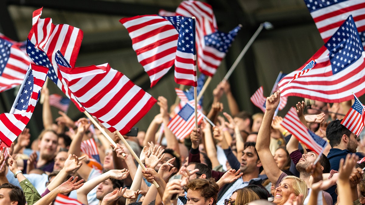 crowd waving American flags