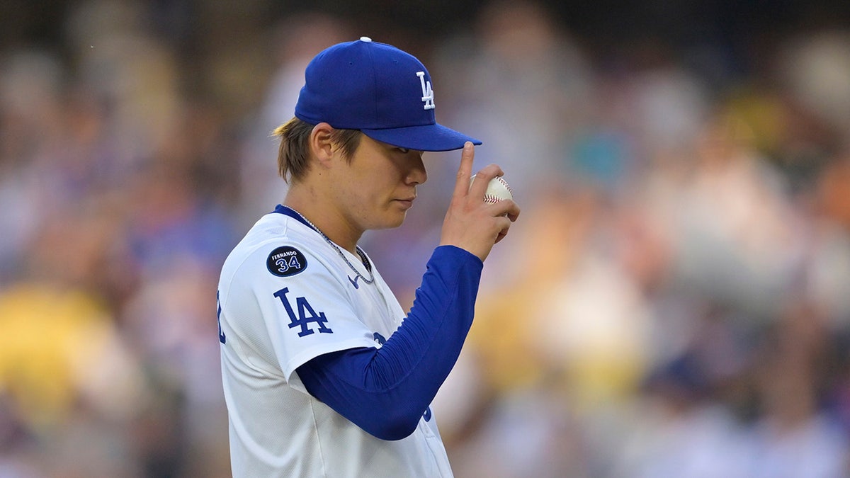 Los Angeles Dodgers pitcher Yoshinobu Yamamoto (18) tips his hat prior to the first pitch against the San Diego Padres during the first inning at Dodger Stadium on June 19, 2025 in Los Angeles, California.