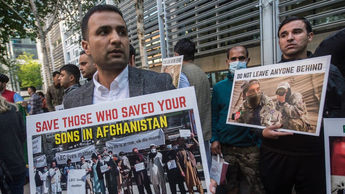 demonstrators hold placards