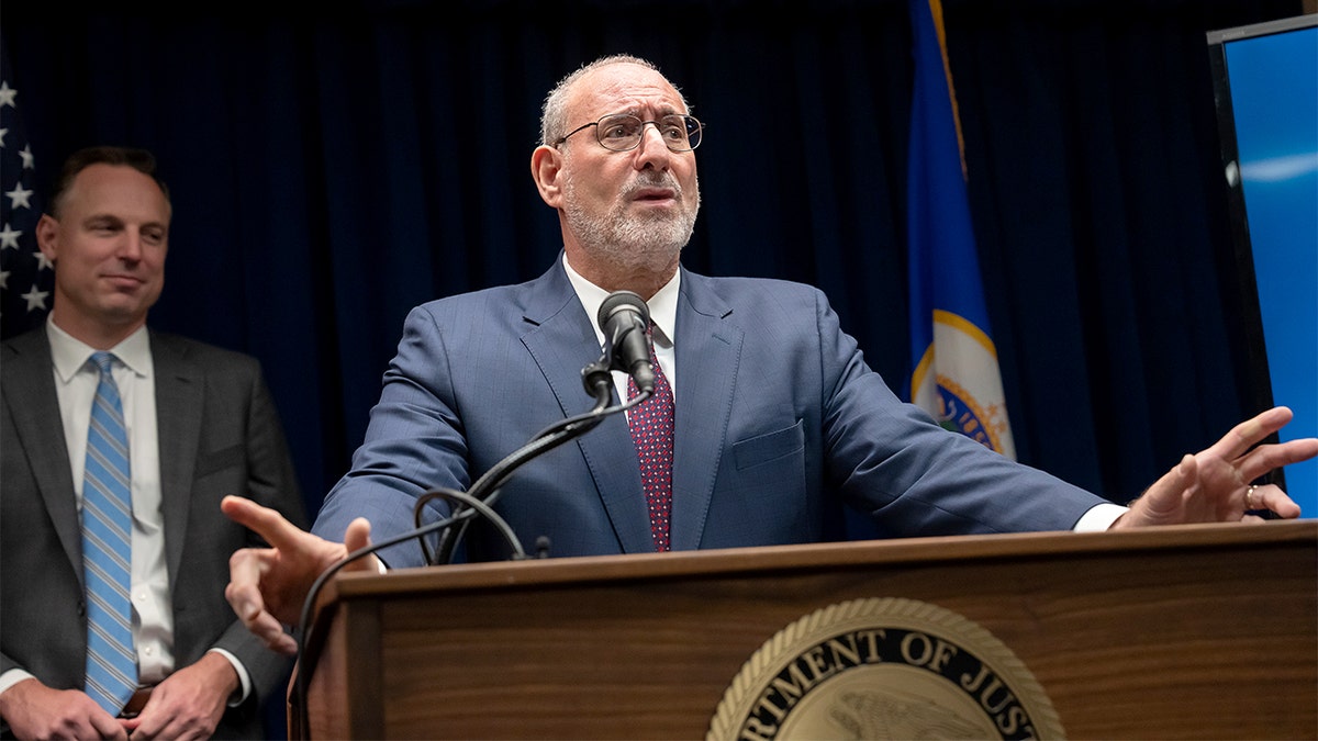 US Attorney Andrew Luger speaks at a podium