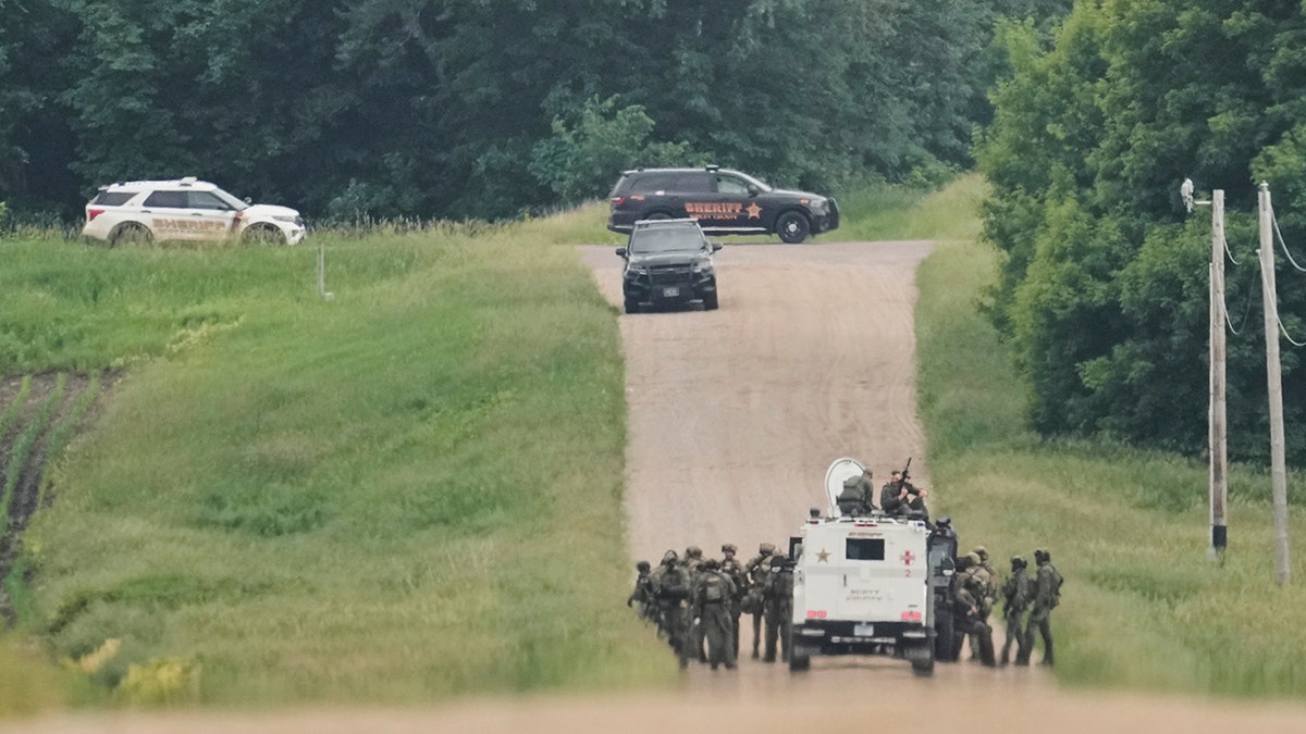 law enforcement searching wooded area