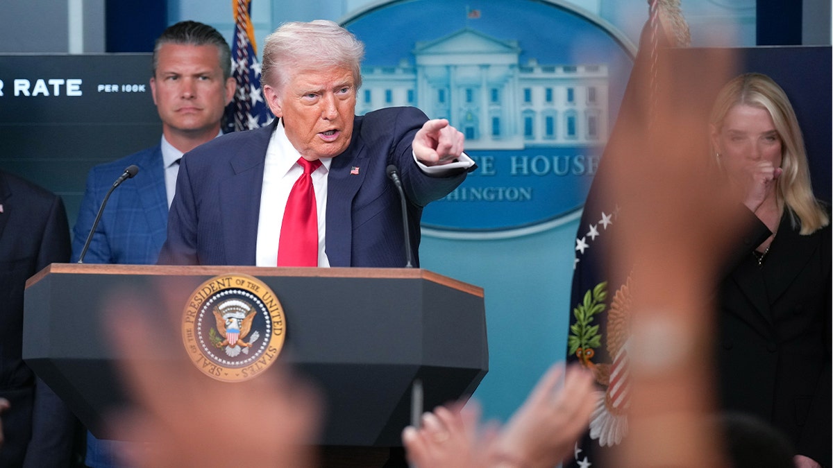 Pete Hegseth, left, President Donald Trump, center, Attorney General Pam Bondi, right.