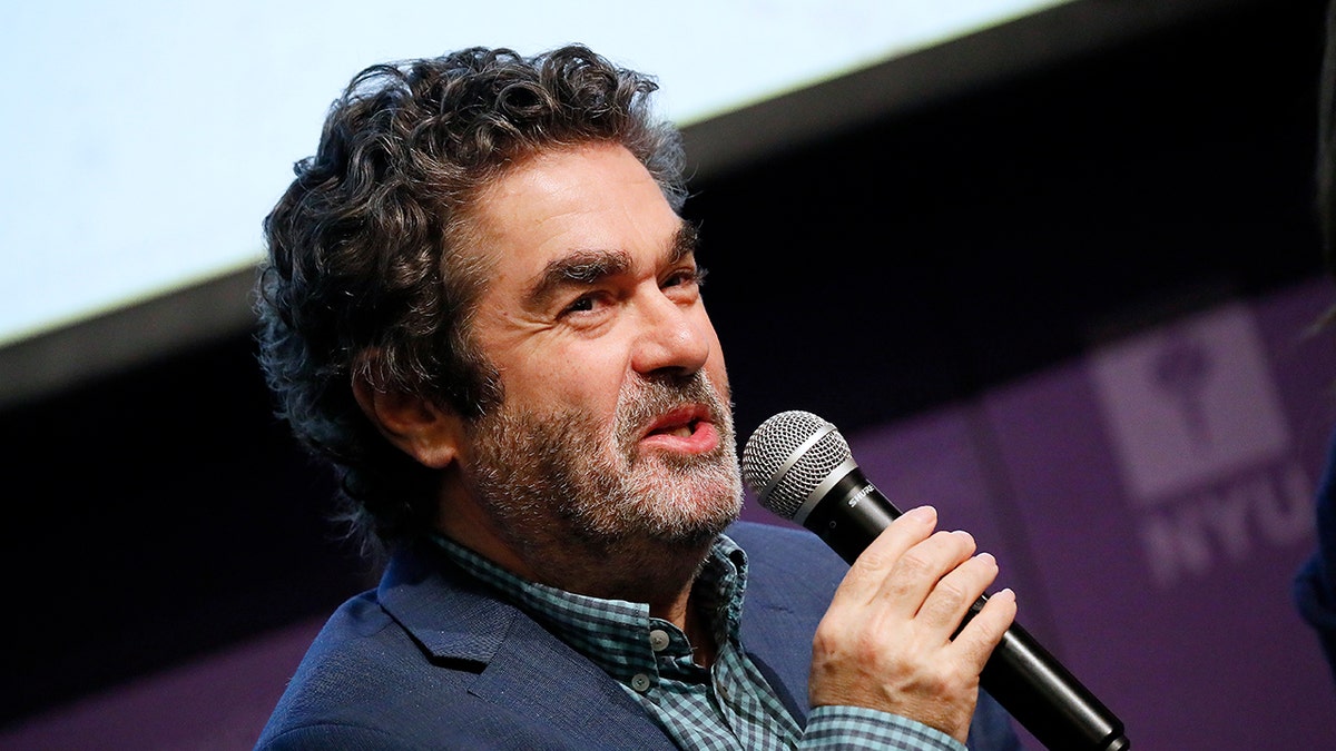 A close-up of Joe Berlinger speaking to a mic.