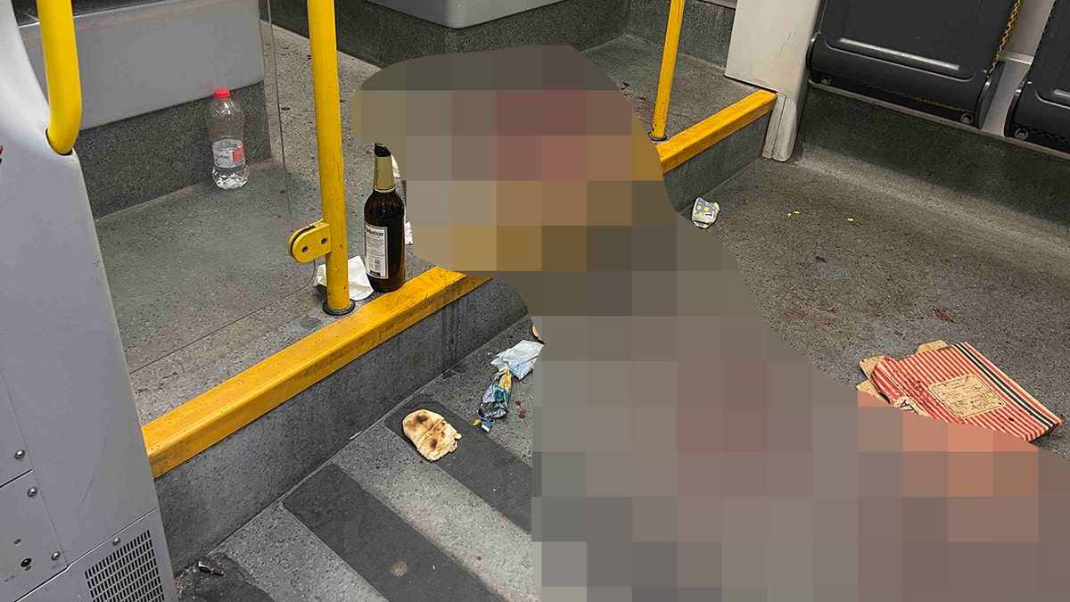 A beer bottle sits next to blood on the floor of a German tram where an American tourist was stabbed. 