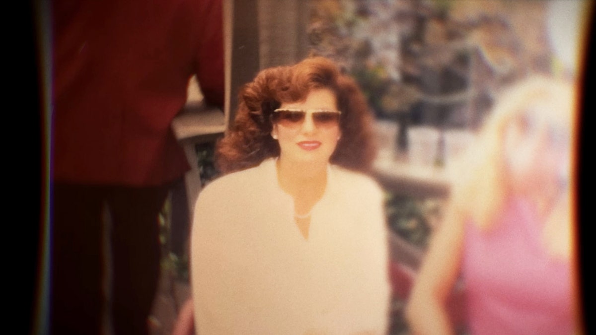 A photo of Bianca Rudolph wearing a white blouse and sunglasses.