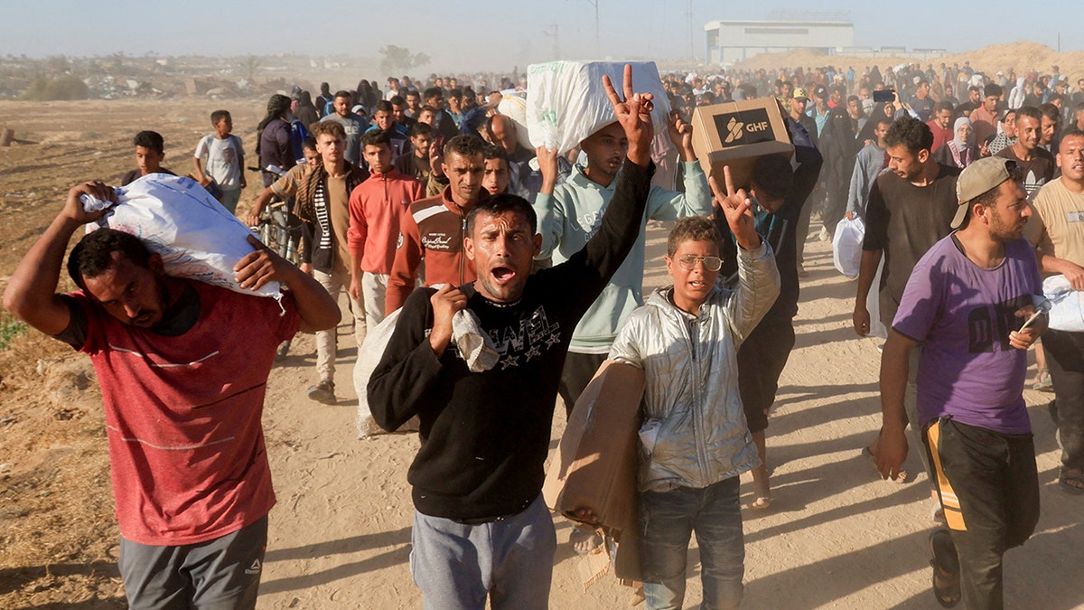 Palestinians carry food aid in Gaza